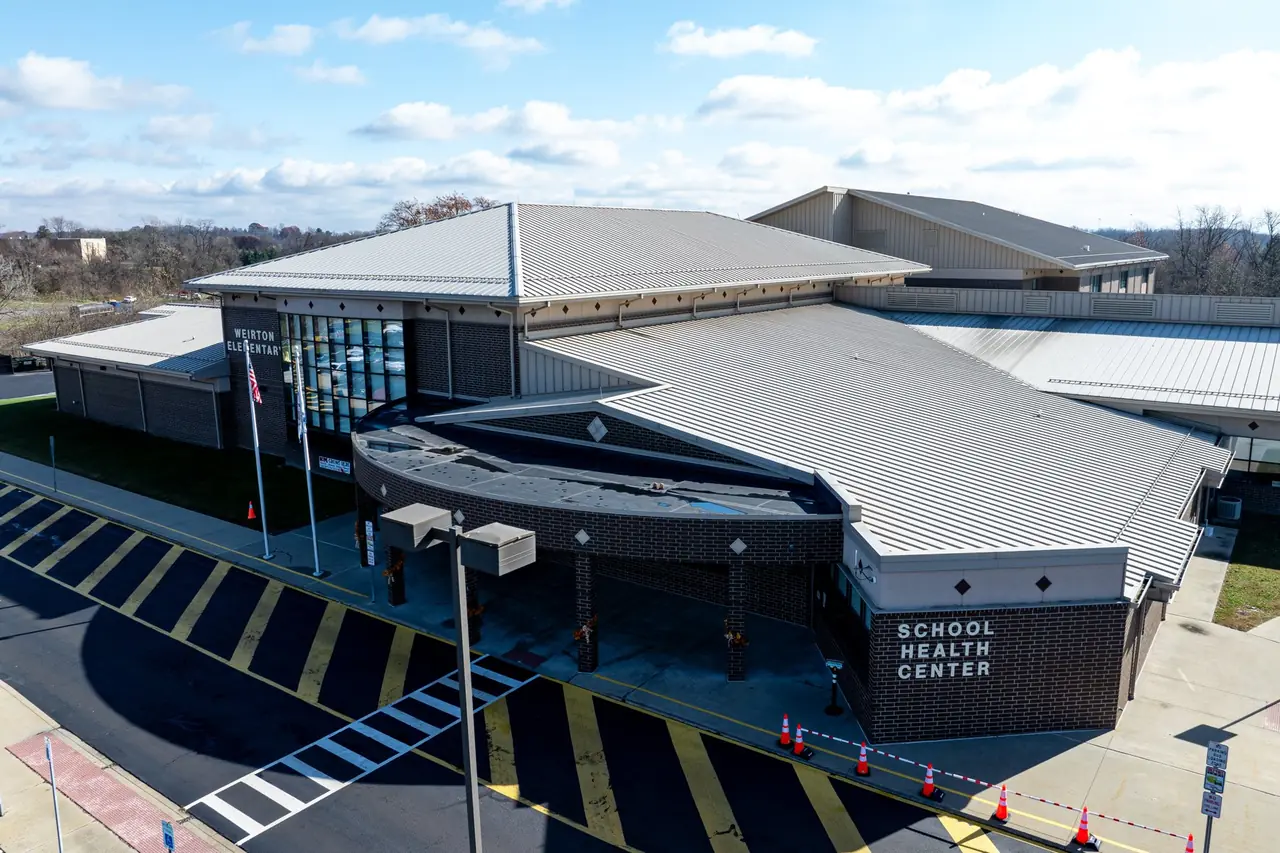 The School Health Center wing of Weirton Elementary under a standing-seam metal roof